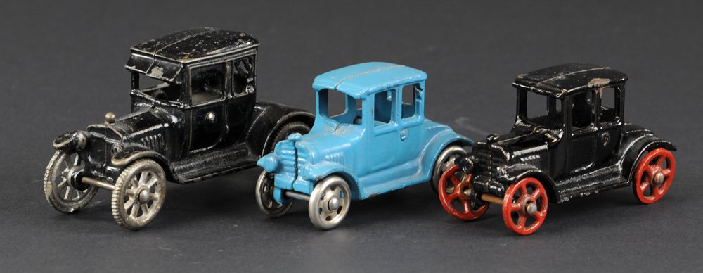 LOT OF THREE MODEL 'T' COUPES: Cast iron examples include: Arcade Coupe with cast curtains, black coupe with red spokes, and blue coupe with nickel spoke wheels. 4 1/4" to 5 1/4" l.