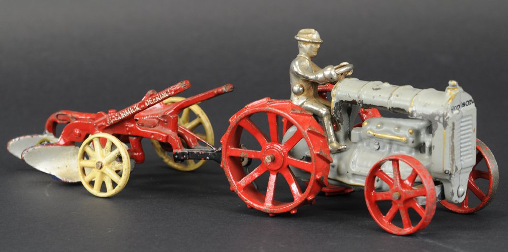 ARCADE FORDSON TRACTOR & PLOW: Cast iron, includes two McCormick Deering bottom plow, and Fordson tractor with seated nickel driver and red spoke wheels. 6" to 6 1/2" l.