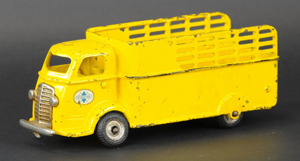 ARCADE INTERNATIONAL STAKE TRUCK: Painted in yellow overall, cab over model, open stake body, nickel grille. 9 1/2" l.