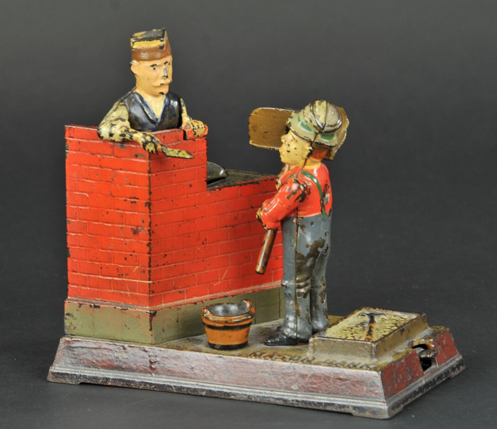 MASON MECHANICAL BANK: Shepard Hardware Co., designed by Charles G. Shepard & Peter Adams, patented 2/8/1887. The comical appearing Hod Carrier receives the coin and throws it forward, depositing it in the bank. The mason r