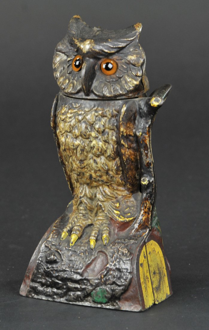 OWL TURNS HEAD MECHANICAL BANK: Brown color, J & E Stevens Co., designed by James H. Bowen, patented 9/28/1880. The above bank has glass eyes and is nicely ornamented in natural colors. Place a coin on the top of the branch, and pre