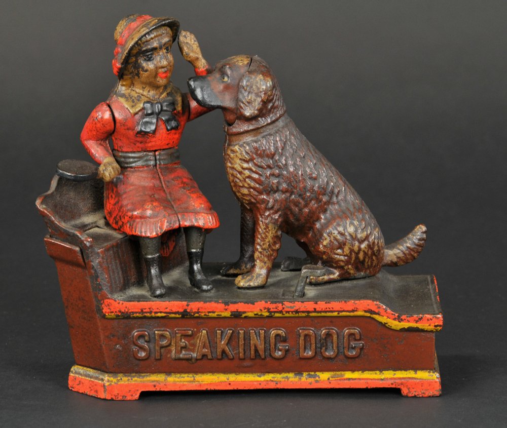 SPEAKING DOG MECHANICAL BANK: Red Dress, Stevens Hardware Co., designed by Charles Shepard & Peter Adams, patented 10/20/1885. The coin is placed in a plate held by the girl. The thumb piece is pressed upon, the girl’s arm moves