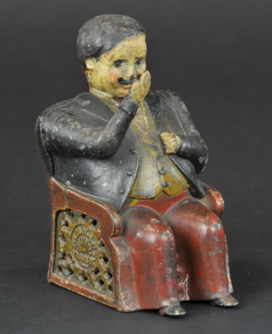TAMMANY MECHANICAL BANK: Brown pants, J & E Stevens Co., designed by John D. Hall, patented 12/23/1873. Put a coin in his hand, and see how promptly he pockets it, and how politely he bows his thanks.