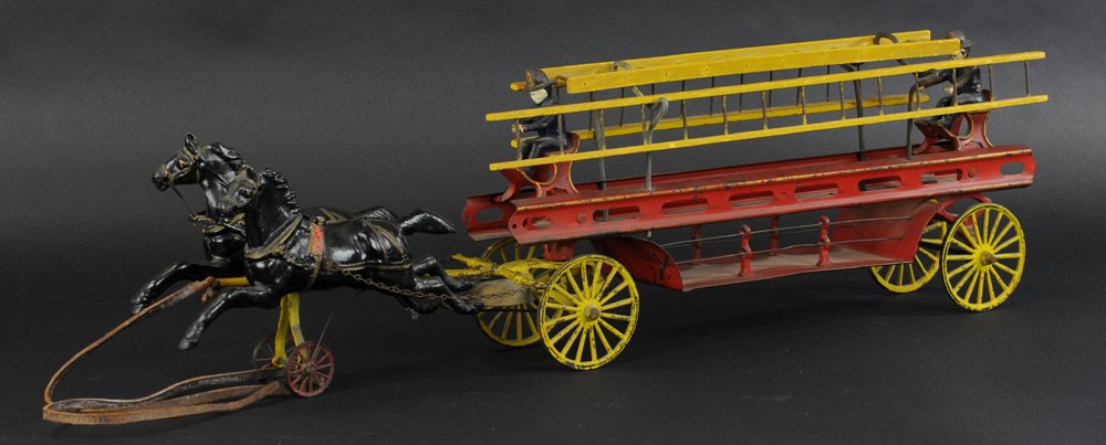 WILKENS HORSE DRAWN LADDER WAGON & DENT TOY CATALO: Cast iron hitch and spoke wheels done in yellow, red open frame stamped steel body, two seated firemen, wood ladders on wire supports, includes Dent Hardware Catalog. 27" l.