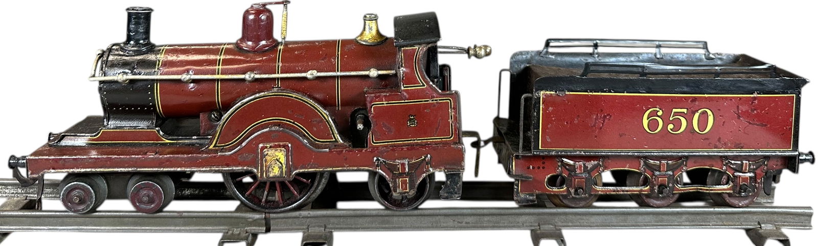 BING FOR BASSETT-LOWKE MIDLAND EXPRESS: 42. BING FOR BASSETT-LOWKE MIDLAND EXPRESS | O gauge, clockwork, litho. | 8" l. loco | Some in-filling to scratches throughout loco and tender, displays in (Very Good to Excellent Condition) | $300 -