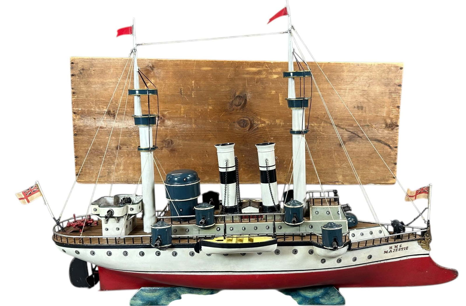 BOXED MARKLIN BATTLESHIP HMS MAJESTIC: 76. BOXED MARKLIN BATTLESHIP HMS MAJESTIC | Germany, circa 1906, handsome clockwork driven ship, it is the ?first generation? of Marklin?s warships featuring an exaggerated ram bow, large cannons, tal