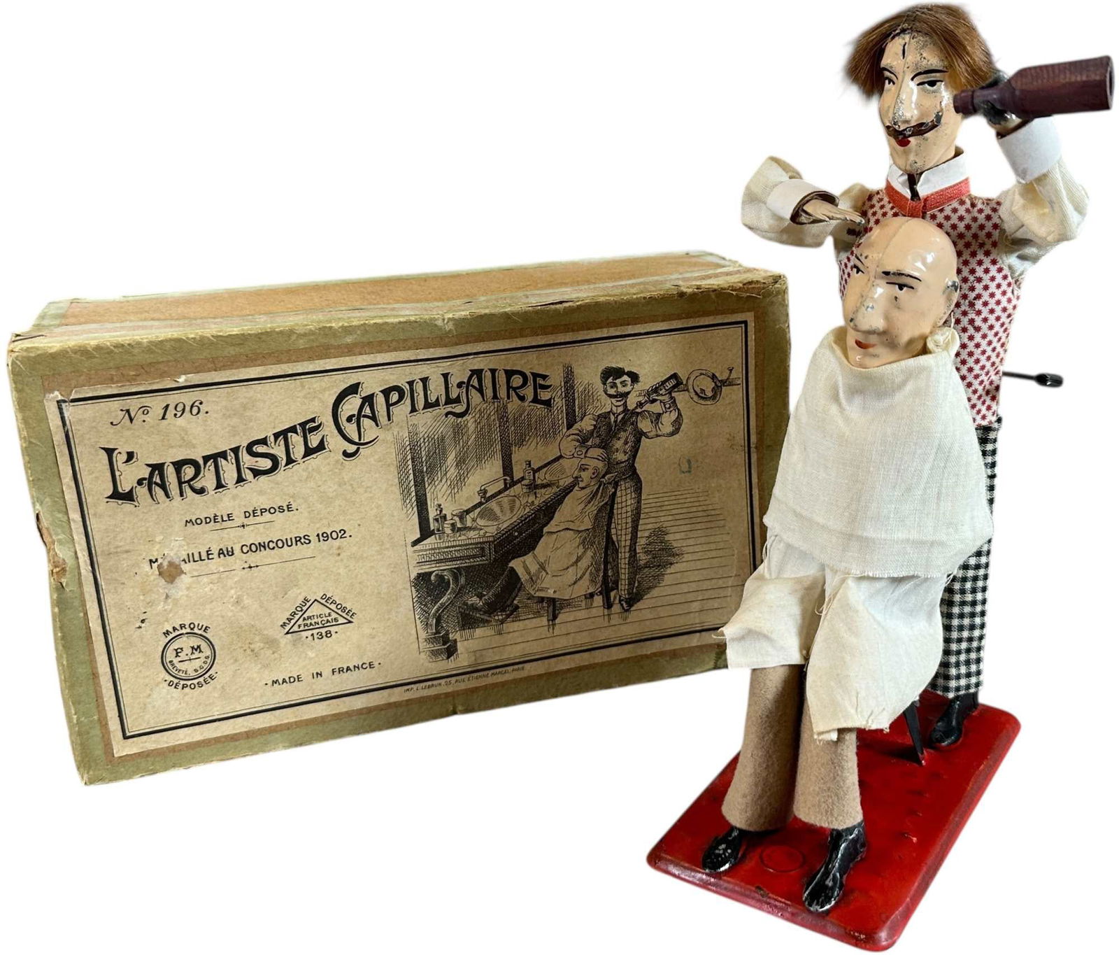 BOXED FERNAND MARTIN THE BARBER: 309. BOXED FERNAND MARTIN THE BARBER | France, circa 1904, wind-up motion, "L'Artiste Capillaire," very amusing action depicts a barber pouring shaving cream onto customers head while spreading it ove