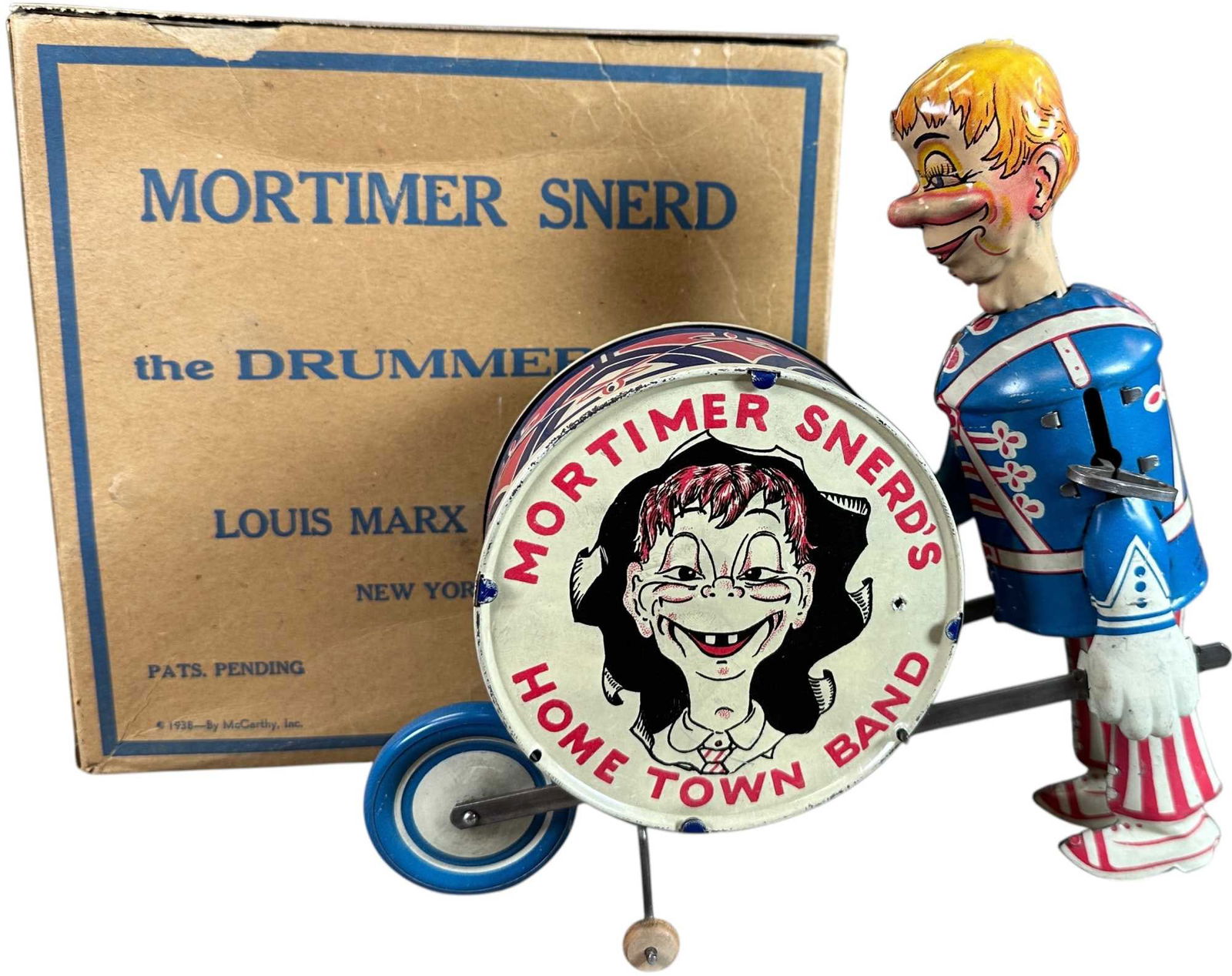 BOXED MARX MORTIMER SNERD DRUMMER: 420. BOXED MARX MORTIMER SNERD DRUMMER | USA, working wind-up motion. Provenance: Richard Mueller Collection. | 8.5" l. | Box missing one inner & one top flap, some minor tears (Very Good to Excellent