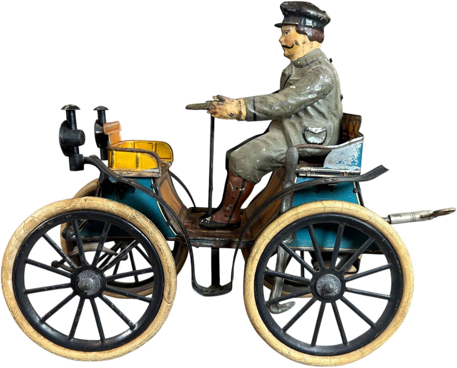 LARGE GUNTHERMANN VIS-A-VIS: 1050. LARGE GUNTHERMANN VIS-A-VIS | Germany, wind-up motor driven. Hand painted figure with lithographed tin auto. Provenance: David Bausch Collection. | 10" l. | Original rubber tires, tab at man's u