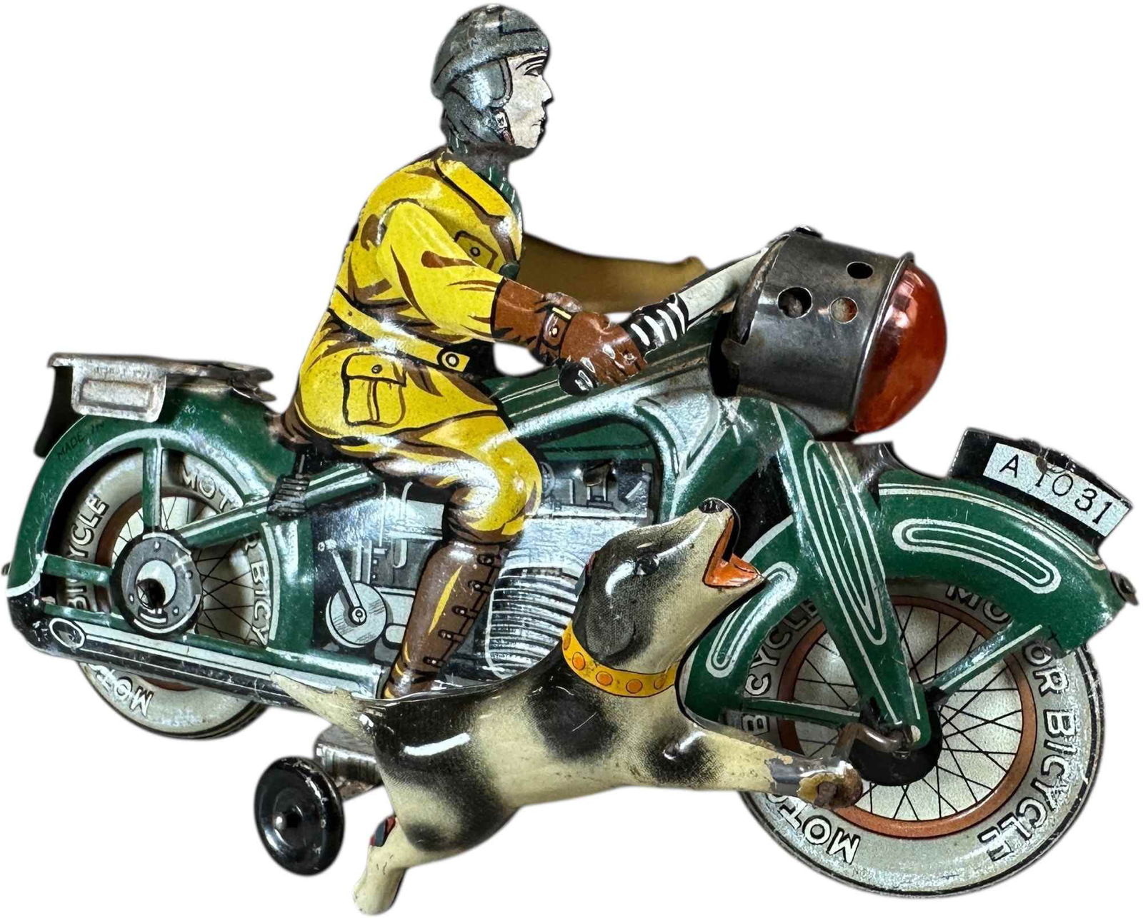 JAPANESE DOG CHASING MOTORCYCLE TOY: 1084. JAPANESE DOG CHASING MOTORCYCLE TOY | Japan circa 1940, wind-up motor, visually captivating and very rare lithographed tin motorcycle depicting a dog running beside a speeding rider. Inspired by
