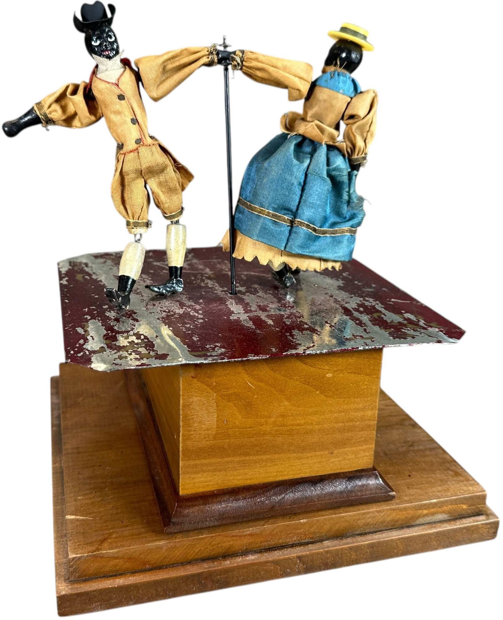 IVES MECHANICAL CAKE WALK DANCERS: 1297. IVES MECHANICAL CAKE WALK DANCERS | Also attributed to Automatic Toy Works, circa 1880s, this is a scarce and seldom offered clockwork American toy, wooden base conceals clockwork motor, when ac