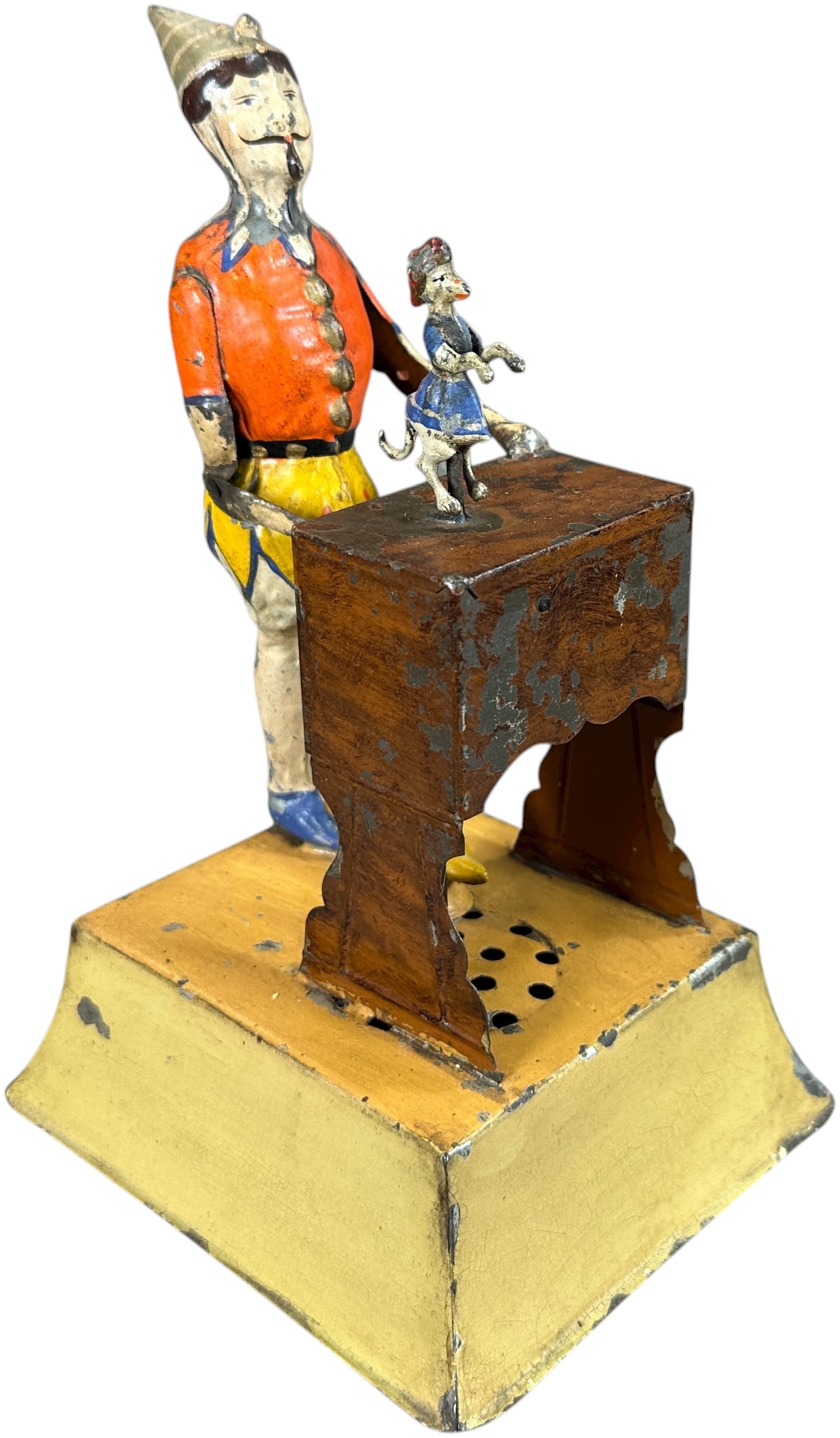 GERMAN ORGAN GRINDER TOY: 105. GERMAN ORGAN GRINDER TOY | Germany, attributed to Gunthermann, wind-up motor causes man to crank his organ as the small dog spins in a dancing circle, plink plank chime music emits from the base.