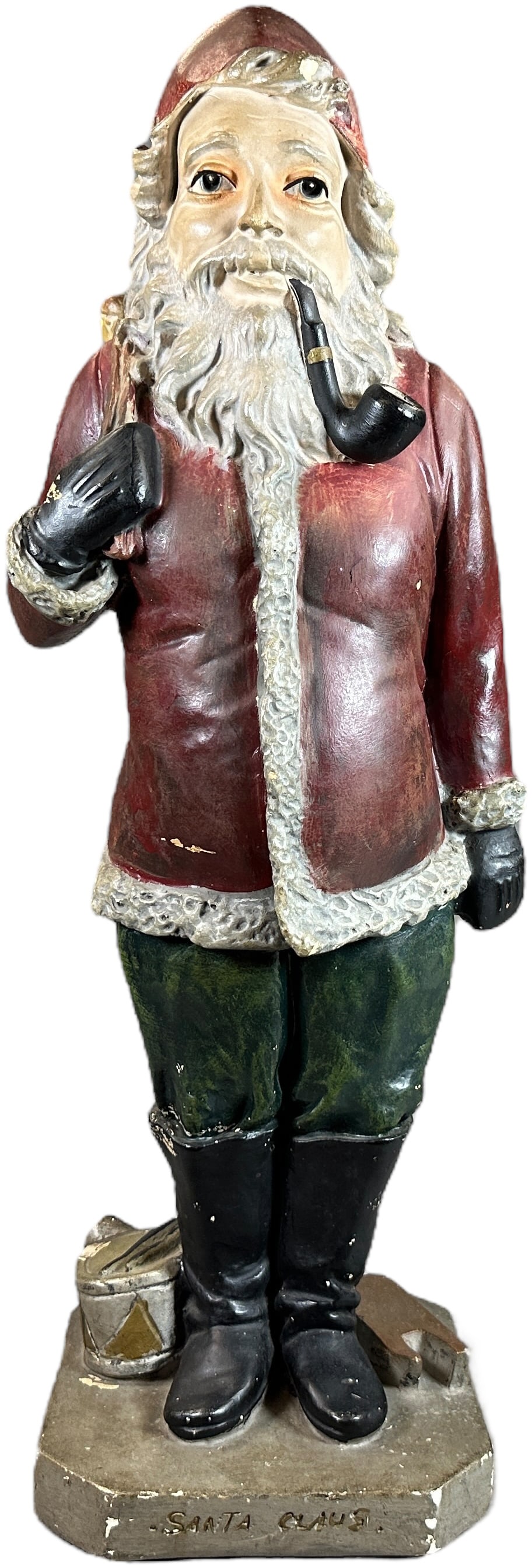 EARLY CHALKWARE SANTA FIGURE: 24. EARLY CHALKWARE SANTA FIGURE | Depiocts a tall Santa smoking a pipe with toy sack slung over his shoulder, fabulous detial throughout, front of base reads "Santa Claus." Provenance: Ed & Brenda