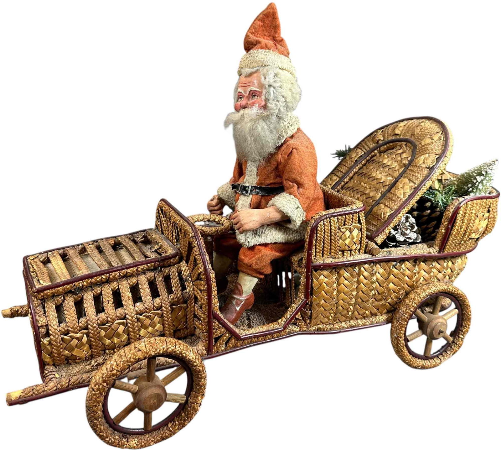 VERY LARGE SANTA IN WICKER CAR: 129. VERY LARGE SANTA IN WICKER CAR | Large car with back that opens for candy or toys. Provenance: Ed & Brenda DeGarbolewski Collection. | 25" h. | Very nicely done in-painting on Santa face, (Excell