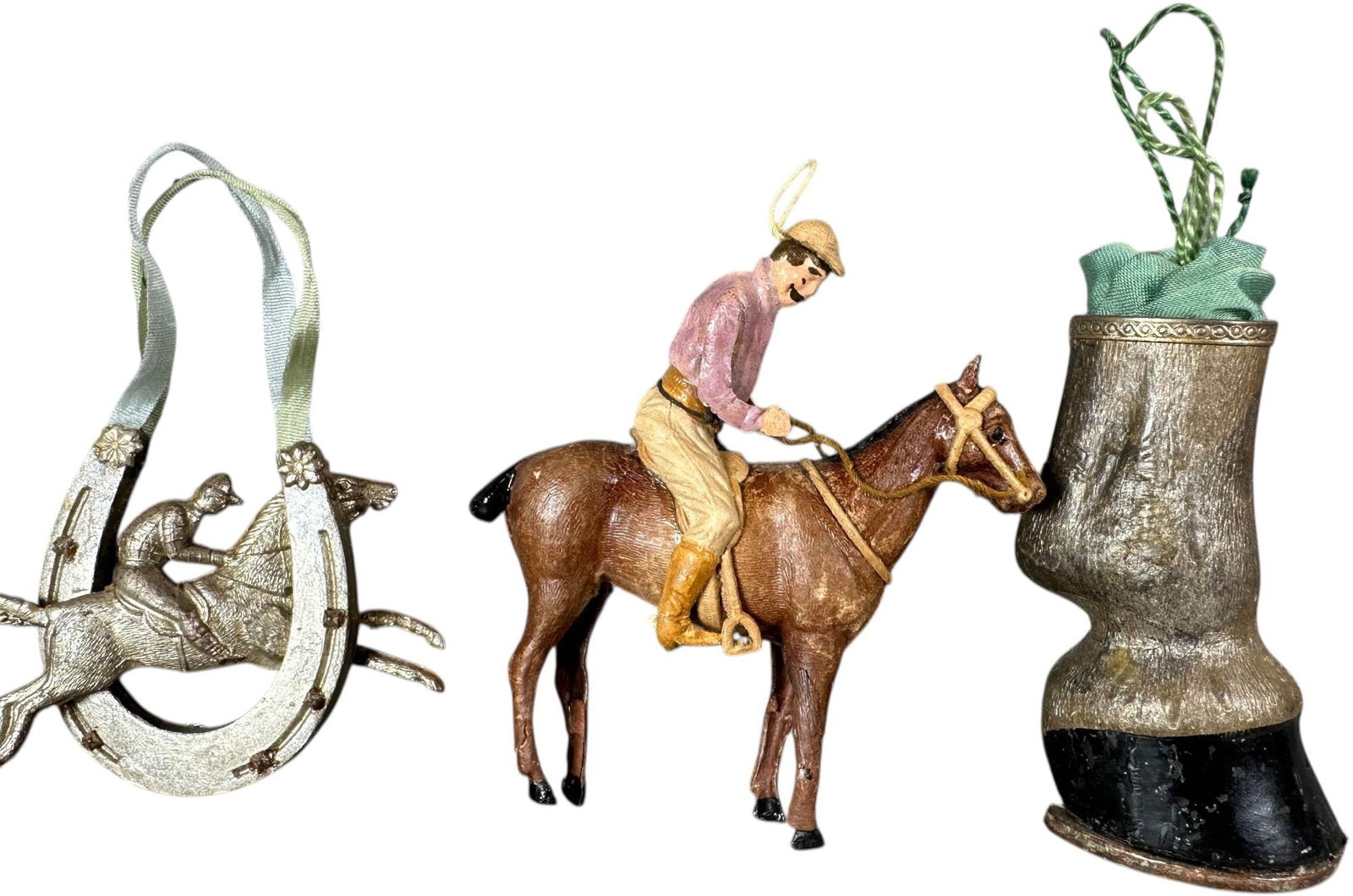 THREE DRESDEN HORSE THEME ORNAMENTS: 132. THREE DRESDEN HORSE THEME ORNAMENTS | Horse foot is a candy container. Provenance: Jerry & Darla Arnold Collection. | 3.5" l. | Minor repairs to horse/jockey piece, (Excellent Condition) | $600 -