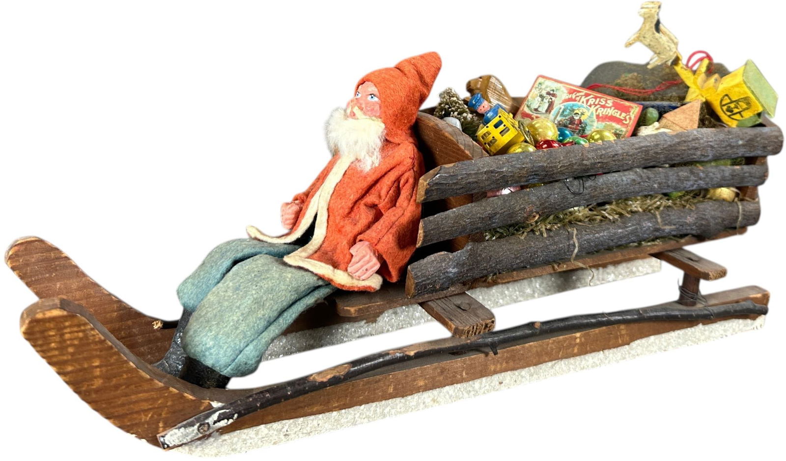 SMALL SANTA CLAUS ON WOOD SLAB SLEIGH: 218. SMALL SANTA CLAUS ON WOOD SLAB SLEIGH | Provenance: Linda Morrow Collection | 14.5" l. | Age related wear to Santa's clothes, overall (Excellent Condition) | $800 - $1,200