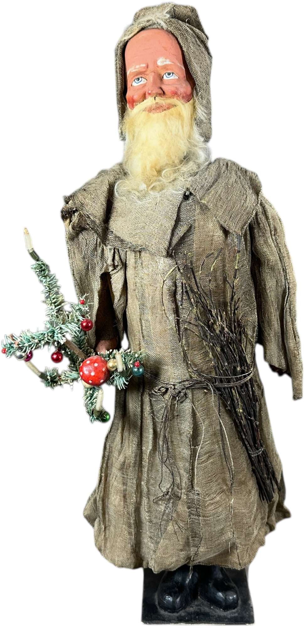 SANTA WEARING BURLAP CANDY CONTAINER: 253. SANTA WEARING BURLAP CANDY CONTAINER | Lined coat lined with crepe paper. Very nice face. Provenance: Linda Morrow Collection | 20.5" h. | Boots and bottom tube are replaced, upper candy tube has