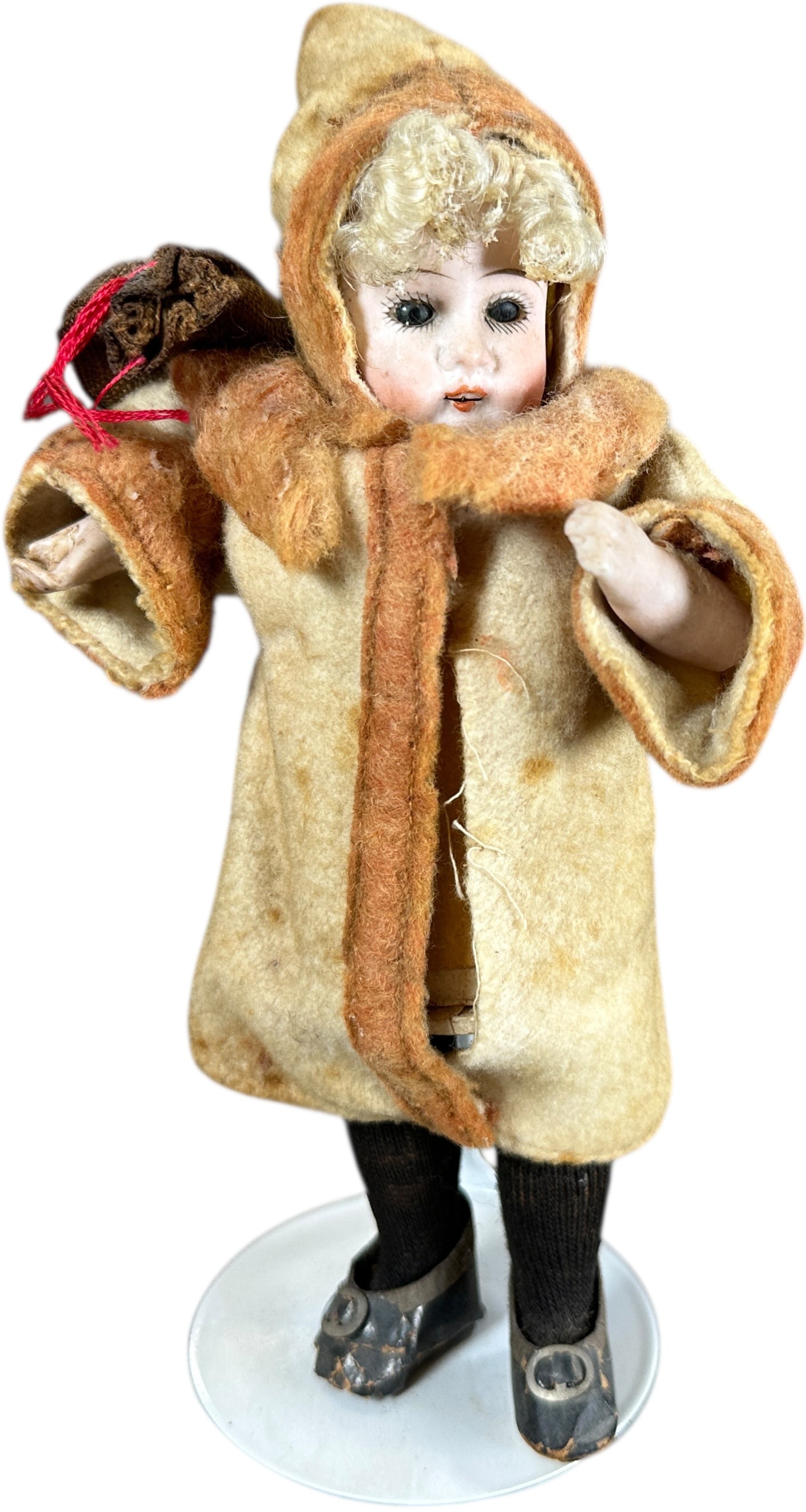 BISQUE HEAD GIRL CANDY CONTAINER: 254. BISQUE HEAD GIRL CANDY CONTAINER | Felt coat and glass eyes, tube body candy container. Provenance: Bob & Maurine Young | 8" h. | (Very Good to Excellent Condition) | $600 - $1,000