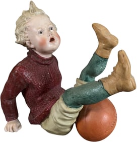 HEUBACH FALLEN BOY W/ RUGBY BALL FIGURINE