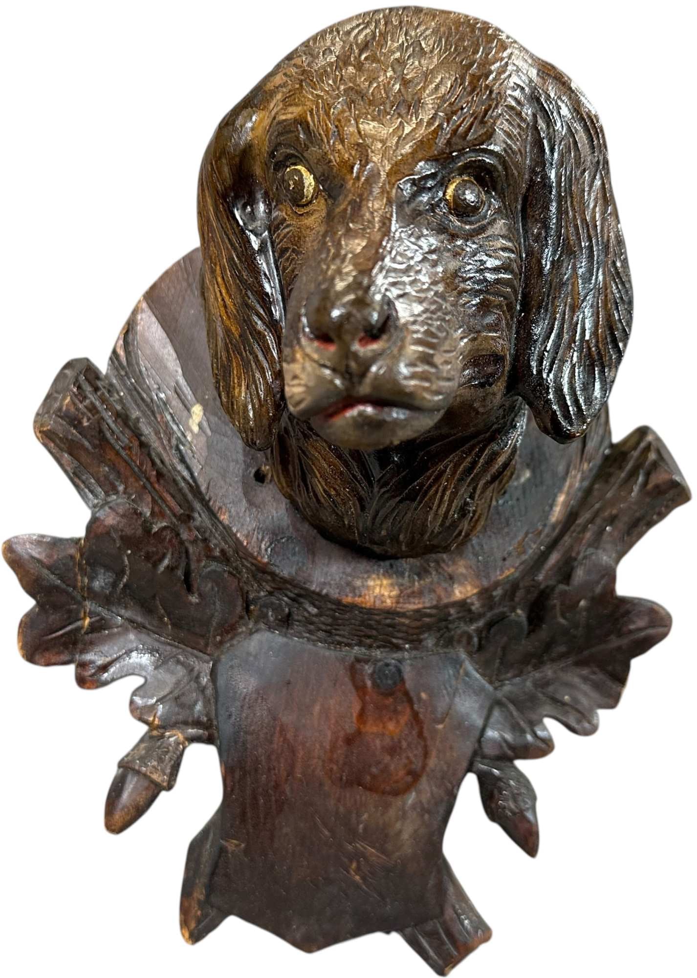 BLACK FOREST CARVED HUNTING DOG PLAQUE: 308. BLACK FOREST CARVED HUNTING DOG PLAQUE | 11.5" h. | One leaf on mount is chipped and other side is cracked and glue, (Very Good to Excellent Condition) | $400 - $800