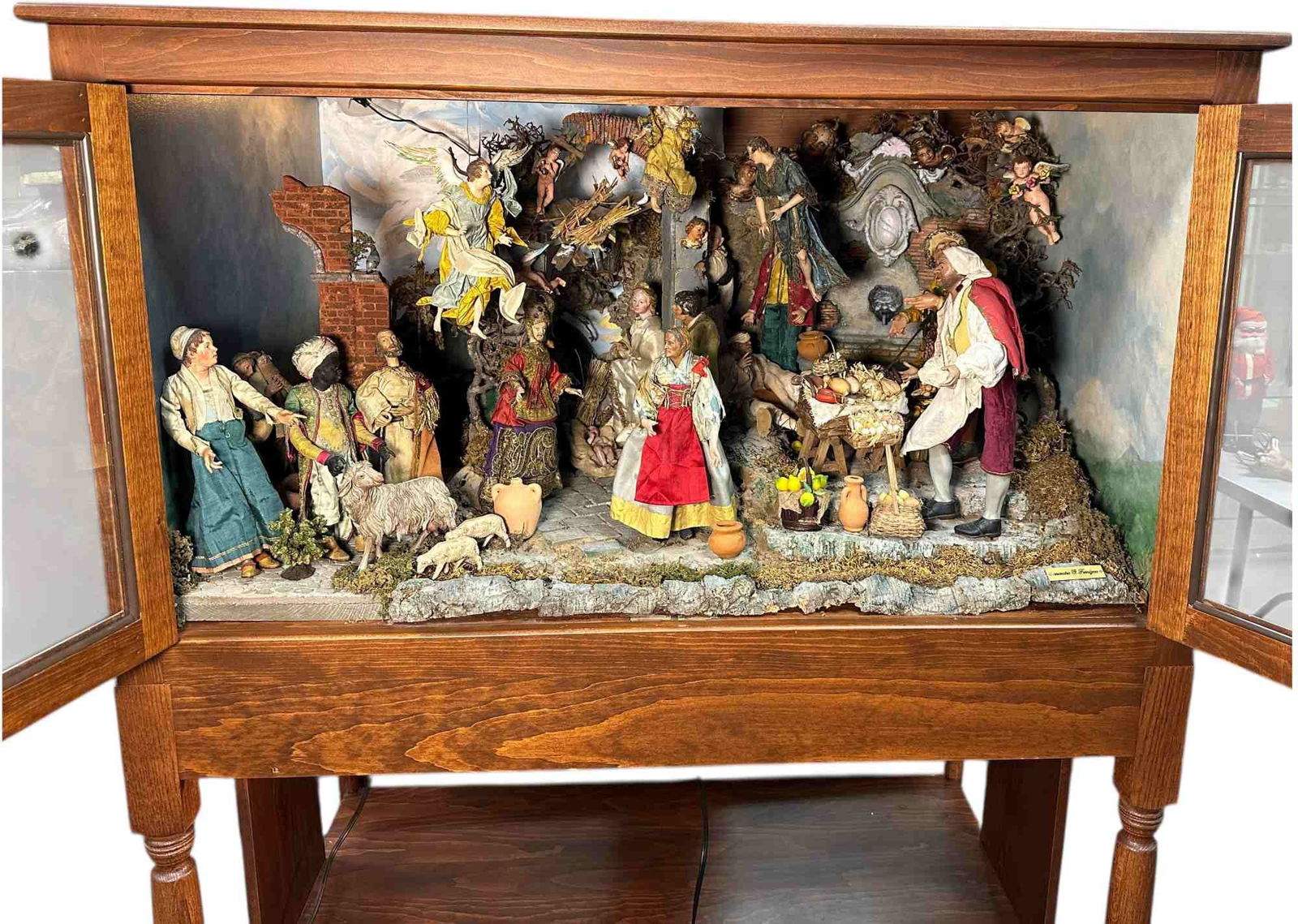 NEAPOLITAN CRECHE FIGURES IN HUGE DISPLAY CASE: 309. NEAPOLITAN CRECHE FIGURES IN HUGE DISPLAY CASE | Over twenty figures with complete detailed background. Very large and is electrified. Includes beautiful animals and Angels. | 8"-10"h. figs.,
