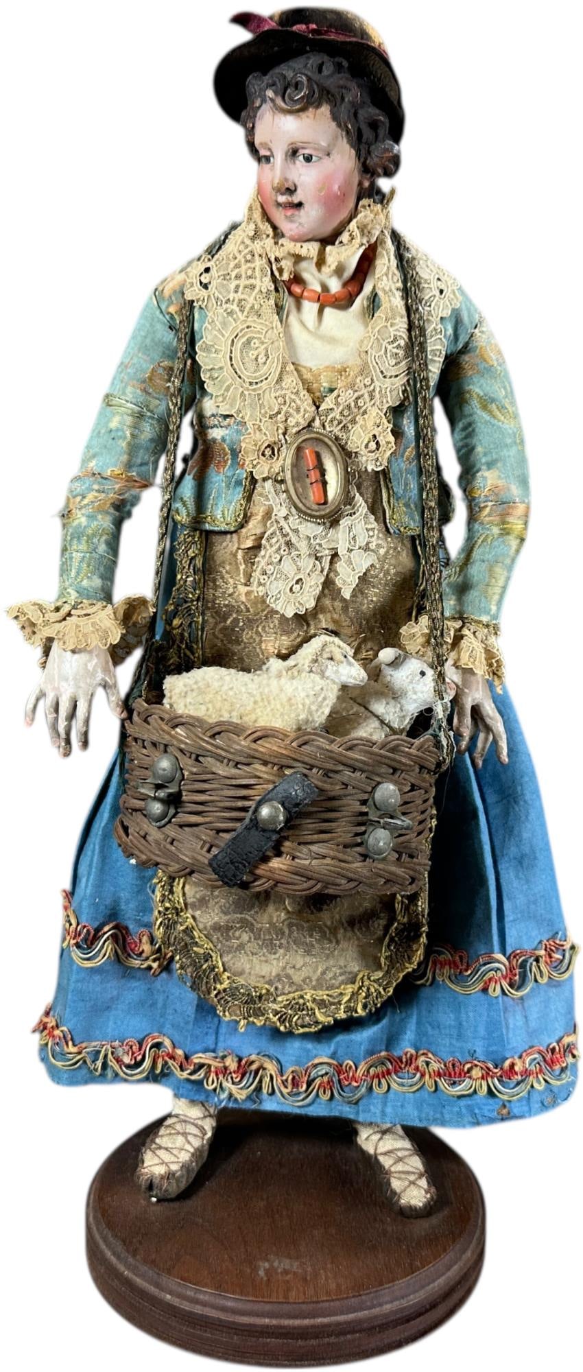 NEAPOLITAN CRECHE NATIVITY SCENE WOMAN FIGURE: 312. NEAPOLITAN CRECHE NATIVITY SCENE WOMAN FIGURE | Beautiful dressed woman with basket of animals. Provenance: Bob & Maurine Young | 16" h. | (Very Good to Excellent Condition) | $600 - $1,200