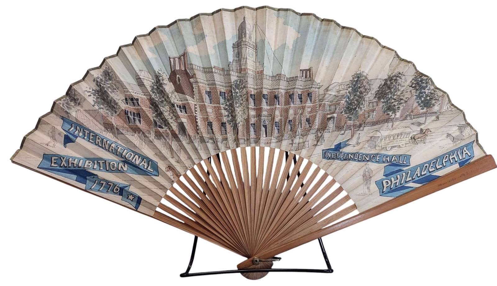 1876 INTERNATIONAL EXHIBITION SOUVENIR FAN: 352. 1876 INTERNATIONAL EXHIBITION SOUVENIR FAN | Celebrating 100 year centennial, hand painted rendering of Philadelphia Independence Hall on one side and 1776-1876 banner with eagle on opposite