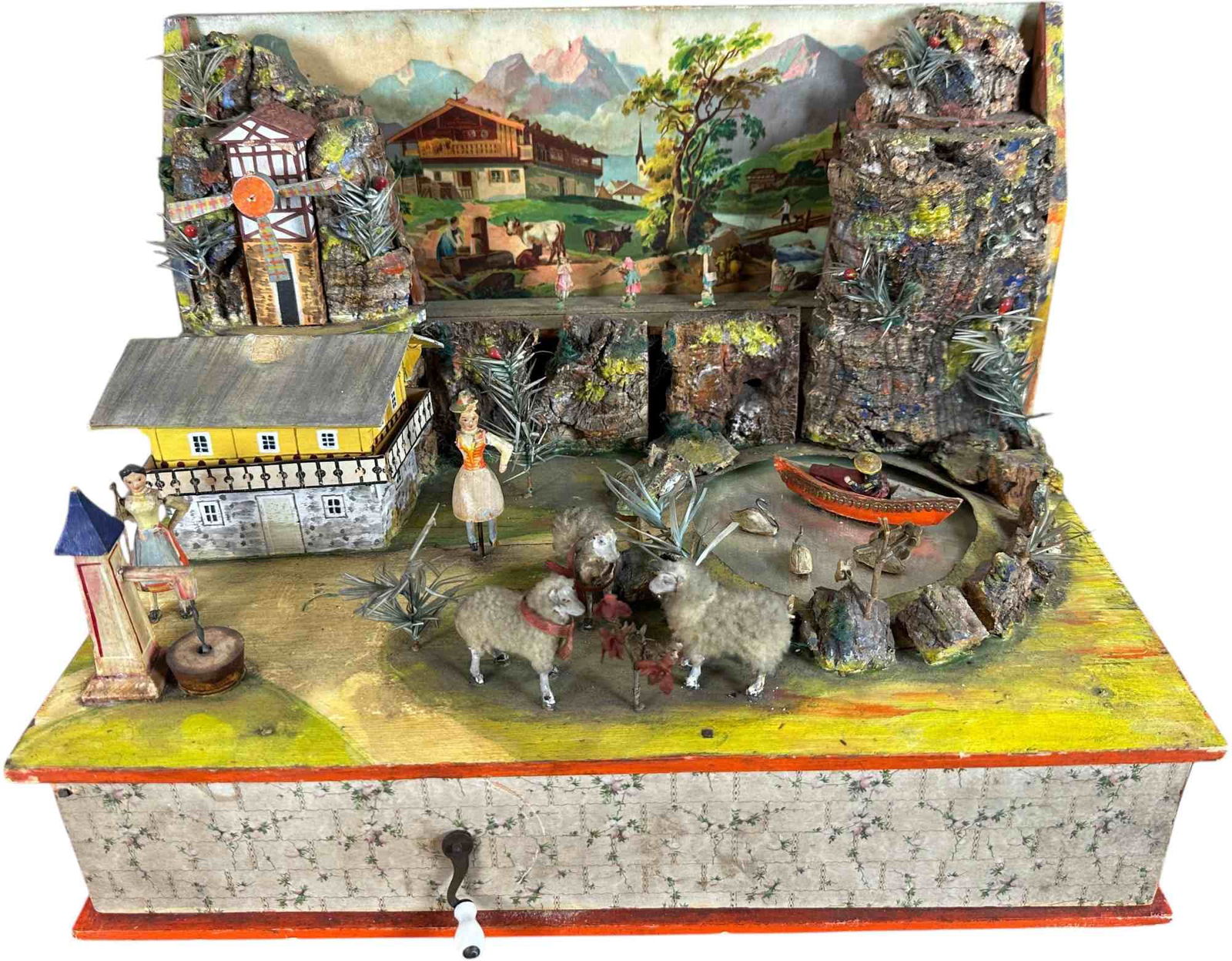 GERMAN HAND CRANK VILLAGE MUSICAL AUTOMATON: 403. GERMAN HAND CRANK VILLAGE MUSICAL AUTOMATON | Hand crank mechanism causes movement of figures throughout the bucolic mountain scene. Provenance: David Bausch Collection. | 14 x 9.5" lw. |