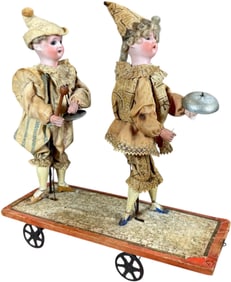 TWO BISQUE HEAD MUSICIANS PULL TOY