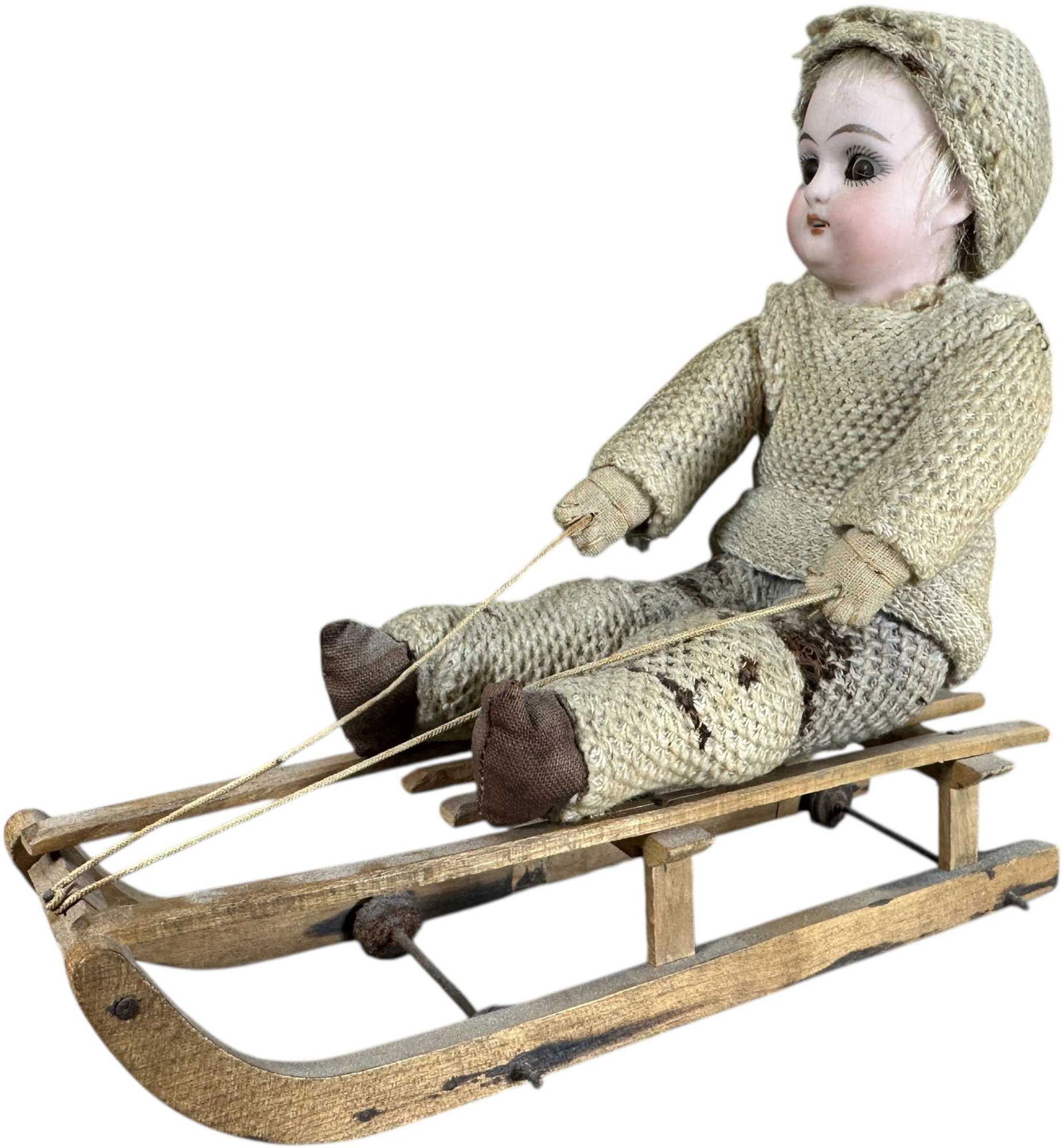 BISQUE HEAD SLEEPY EYE SLEDDING BOY: 1077. BISQUE HEAD SLEEPY EYE SLEDDING BOY | Some damage to pants. | 6.5" h. | (Very Good to Excellent Condition) | $400 - $700