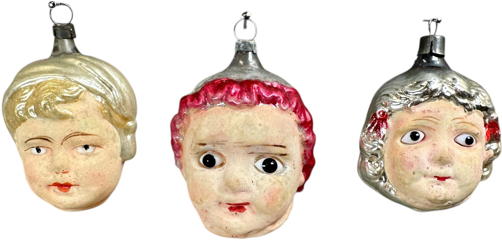 GIRLS HEAD GLASS ORNAMENTS: 1149. GIRLS HEAD GLASS ORNAMENTS | Great painted faces, two with glass eyes. | 3" h. | (Excellent to Pristine Condition) | $400 - $700