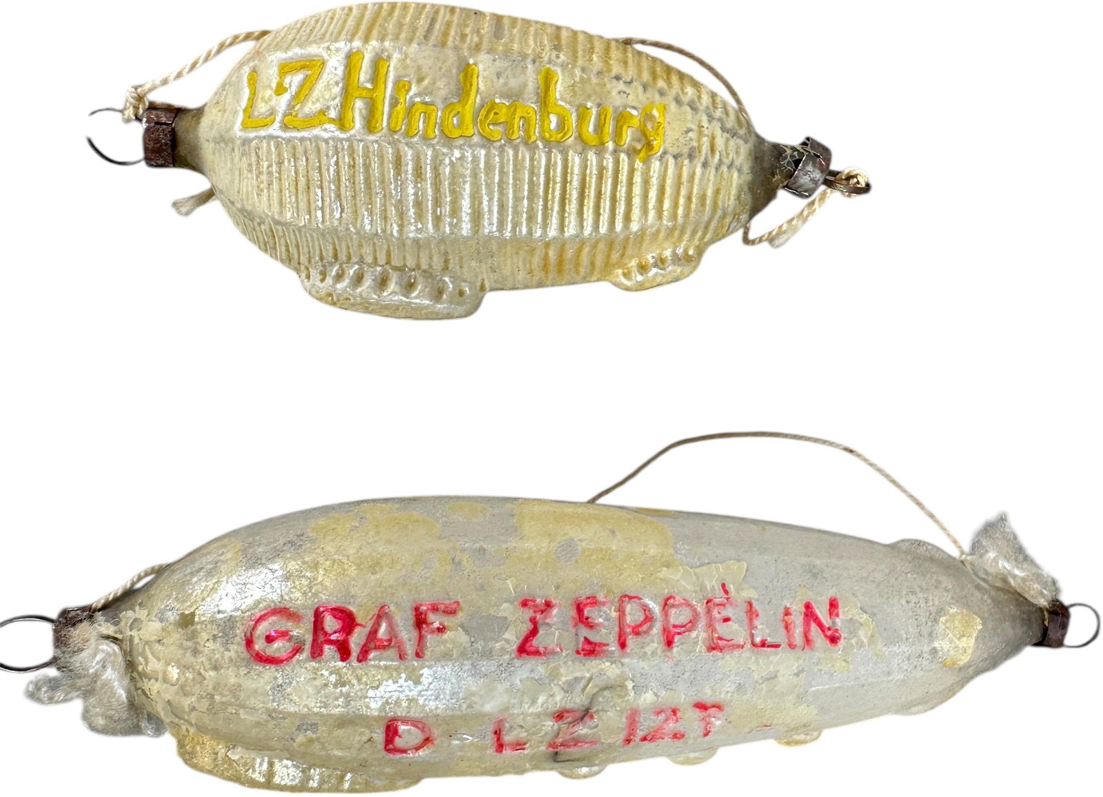 TWO ZEPPELINS GLASS ORNAMENTS: 1151. TWO ZEPPELINS GLASS ORNAMENTS | Good surface. | 6" h. | (Excellent Condition) | $400 - $600