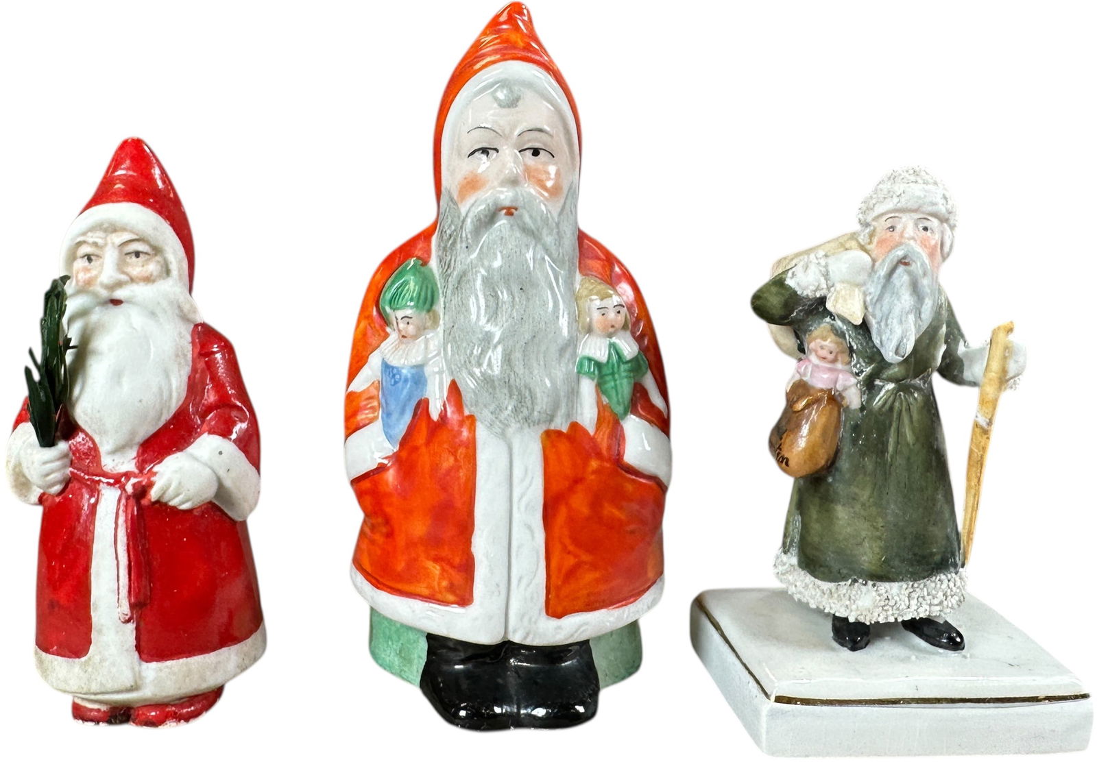 THREE CERAMIC SANTAS FIGURINES: 1163. THREE CERAMIC SANTAS FIGURINES | Early German examples. | 4.5" h. | (Excellent Condition) | $300 - $600
