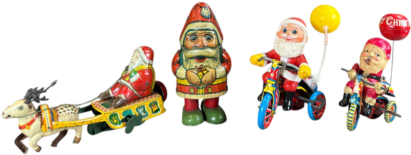 FOUR SMALL WIND-UP TIN SANTA TOYS: 1166. FOUR SMALL WIND-UP TIN SANTA TOYS | 6" h. | (Very Good to Excellent Condition) | $200 - $400