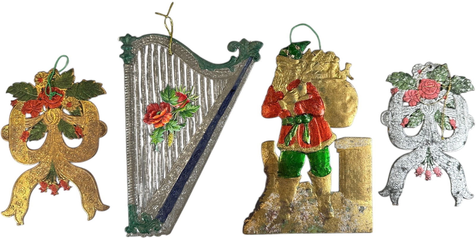 FOUR FLAT DRESDEN ORNAMENTS: 1198. FOUR FLAT DRESDEN ORNAMENTS | Santa hat needs repair. Provenance: Bob & Maurine Young | 7" l. | (Excellent Condition) | $600 - $1,000