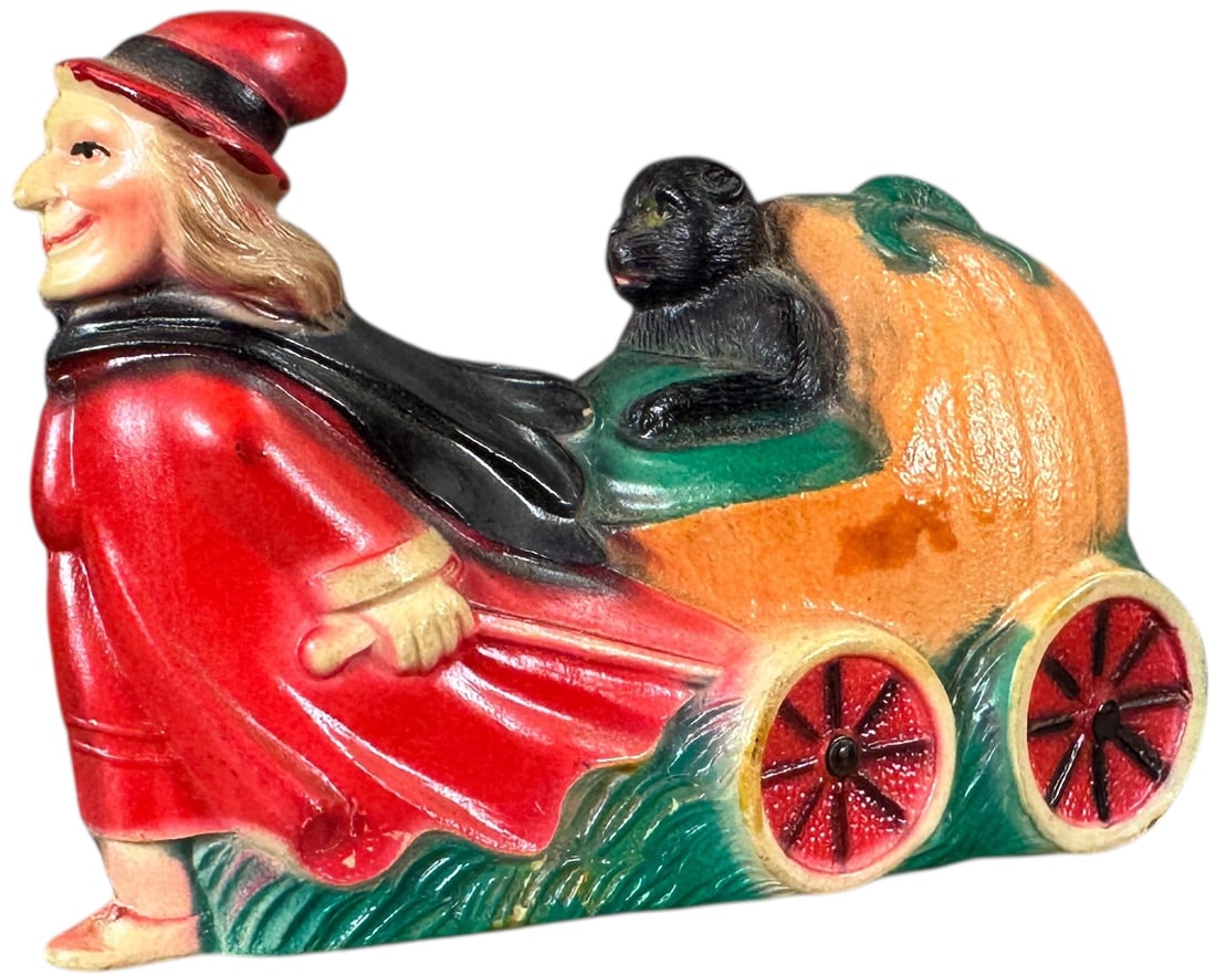 CELLULOID WITCH PULLING CAT IN PUMPKIN CART: 1254. CELLULOID WITCH PULLING CAT IN PUMPKIN CART | Very clean, no dents or cracks. | 3.5" l. | (Pristine to Near Mint Condition) | $500 - $800
