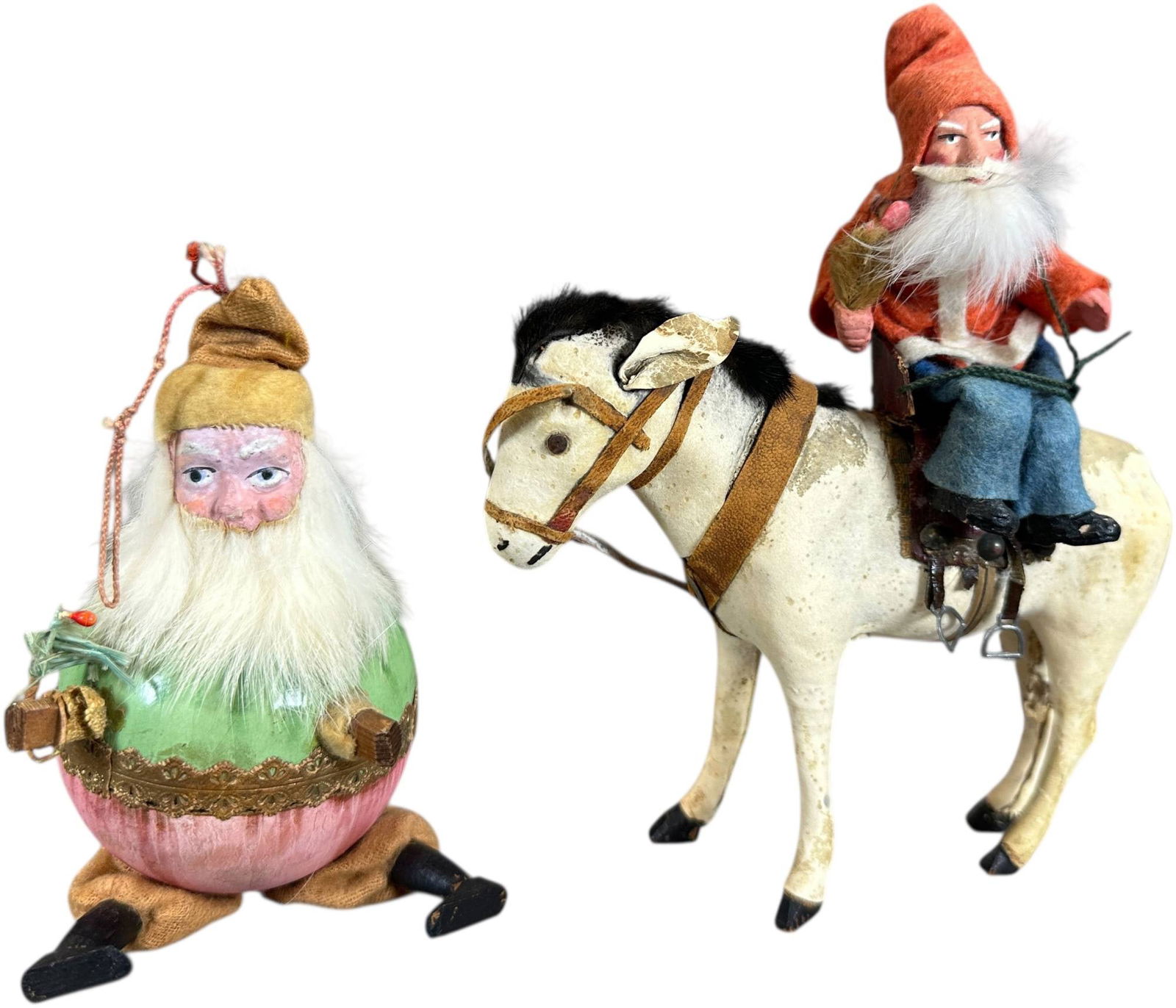 TWO GERMAN SANTA CLAUS PIECES: 1272. TWO GERMAN SANTA CLAUS PIECES | Early Santa with ball body, small Santa riding side sadlle. | 6" h. | (Very Good to Excellent Condition) | $400 - $700