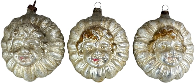 THREE GLASS HEADS ON FLOWERS ORNAMENTS