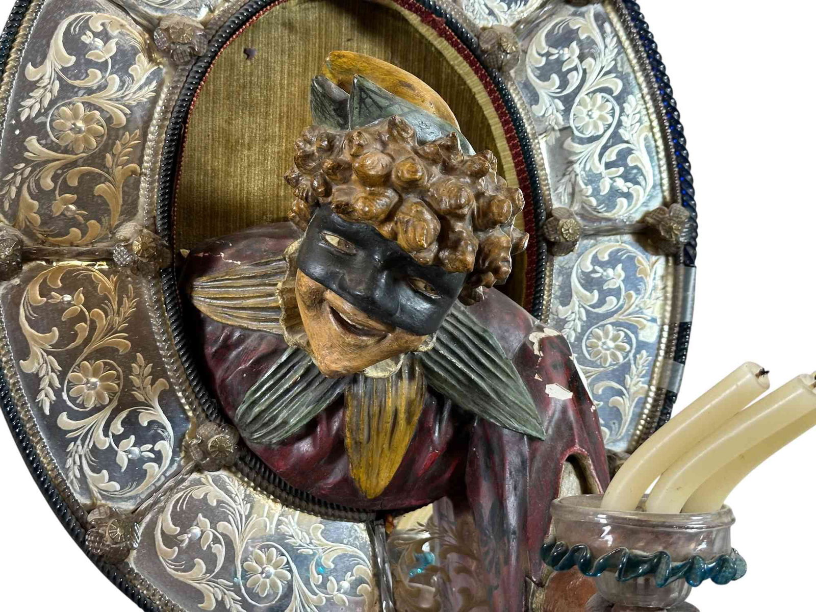WALL MOUNTED JESTER CANDLE HOLDER: 1304. WALL MOUNTED JESTER CANDLE HOLDER | Amusing Victorian era decorative wall hanging with elaborate mirrored border, jester seems to be emerging from the frame to offer a glass candle holder to
