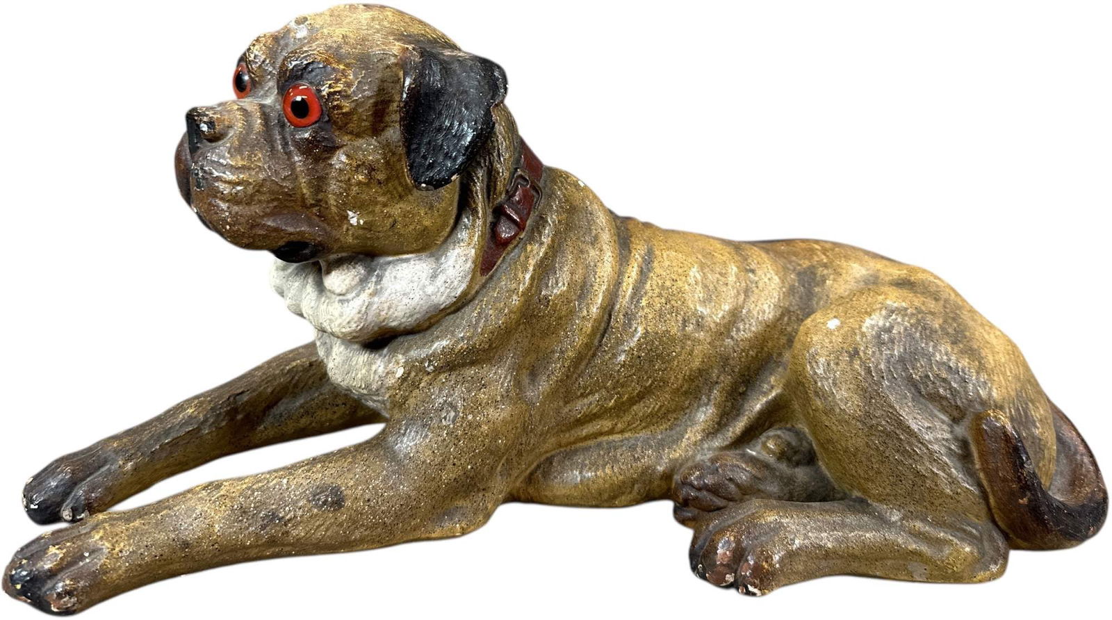 CHALKWARE LAYING BOXER DOG FIGURE: 1307. CHALKWARE LAYING BOXER DOG FIGURE | Nice detail, glass eyes. | 14.5" l. | (Excellent Condition) | $400 - $700