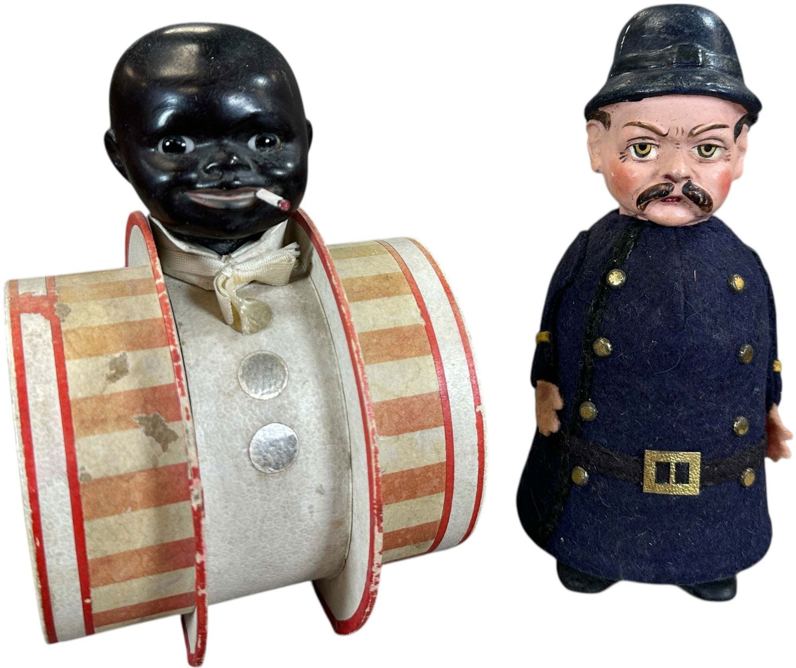 TWO UNUSUAL EARLY CANDY CONTAINERS: 1394. TWO UNUSUAL EARLY CANDY CONTAINERS | Provenance: Beth Karp Collection. | 8" h. | Great face on the policeman with minor touchup at neck and a crack in (Excellent Condition) | $400 - $800