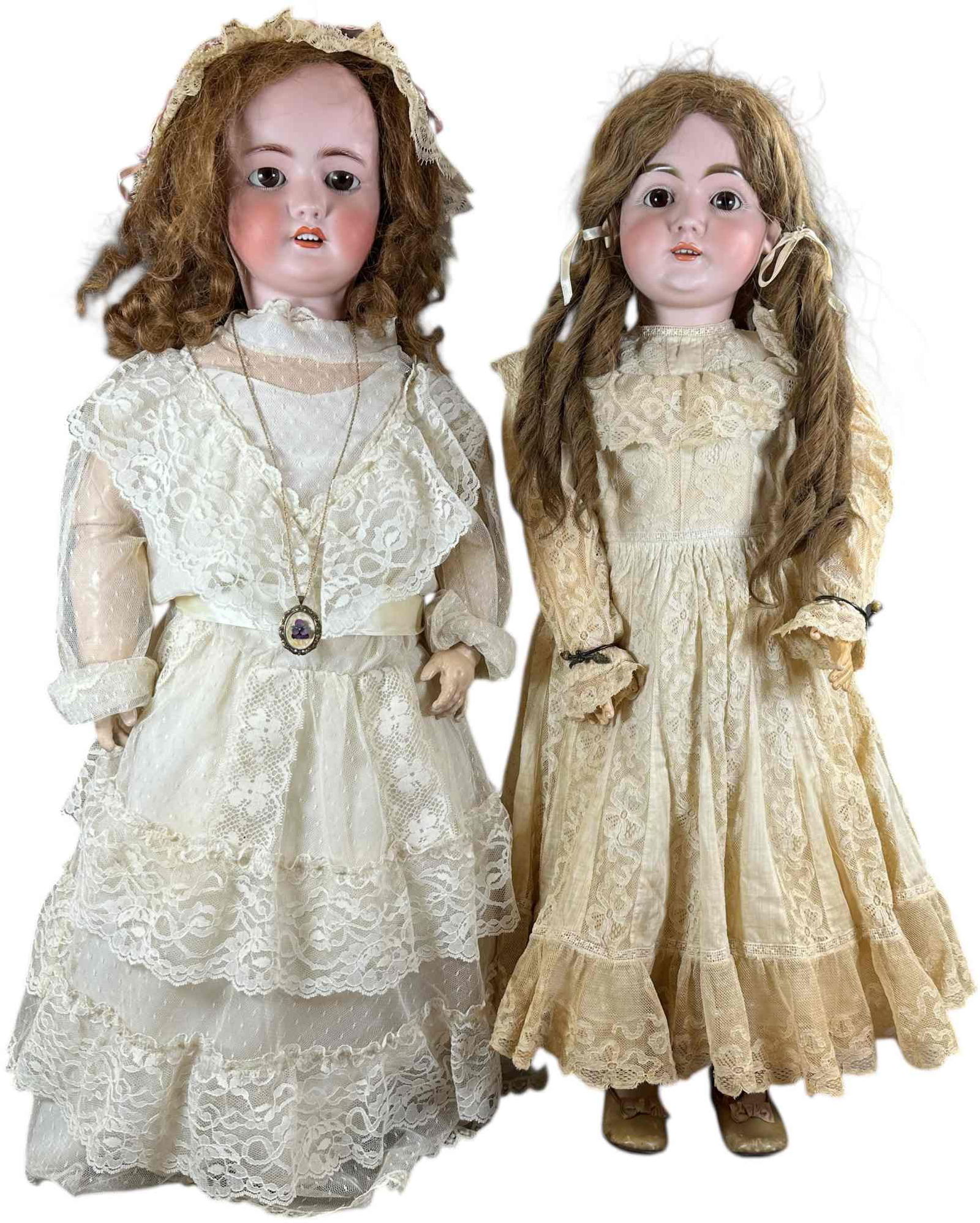 TWO LARGE GERMAN BISQUE HEAD DOLLS: 1423. TWO LARGE GERMAN BISQUE HEAD DOLLS | Slightly larger doll is a Kestner (mold 146 size 16 1/2), with excellent original body, antique wig, brown sleep eyes and original plaster pate; other doll i