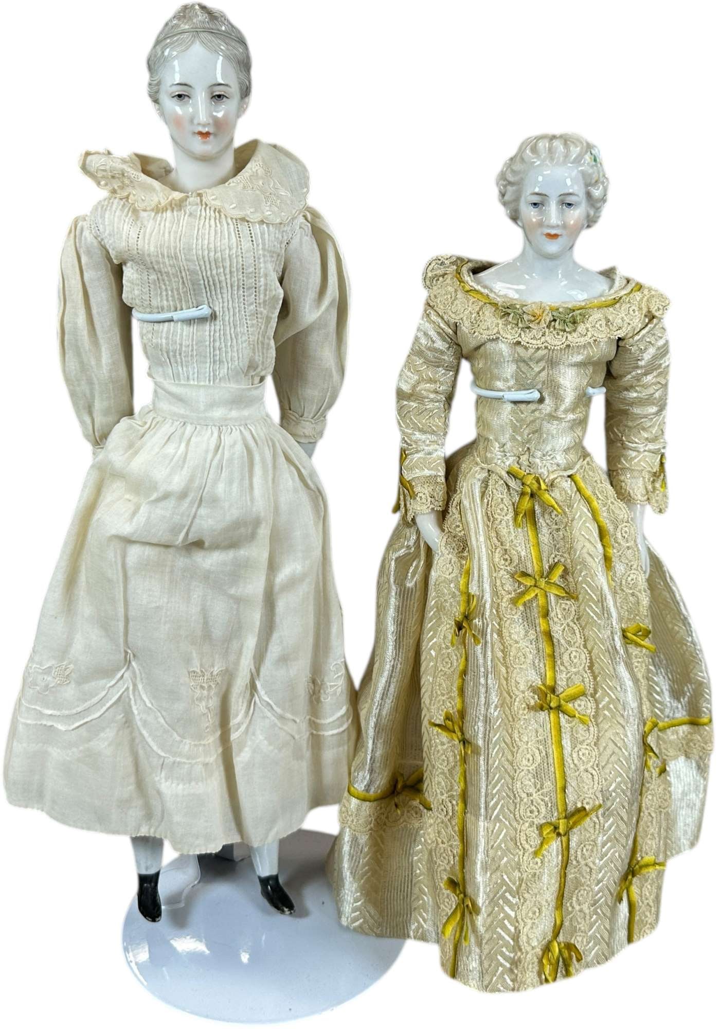 TWO EARLY 20TH CENTURY CHINA DOLLS: 1452. TWO EARLY 20TH CENTURY CHINA DOLLS | Both dolls, which are of the "Dressel Kister-Nymph Enberg" types, were sold primarily as heads (and often with like porcelain arms" which could be made