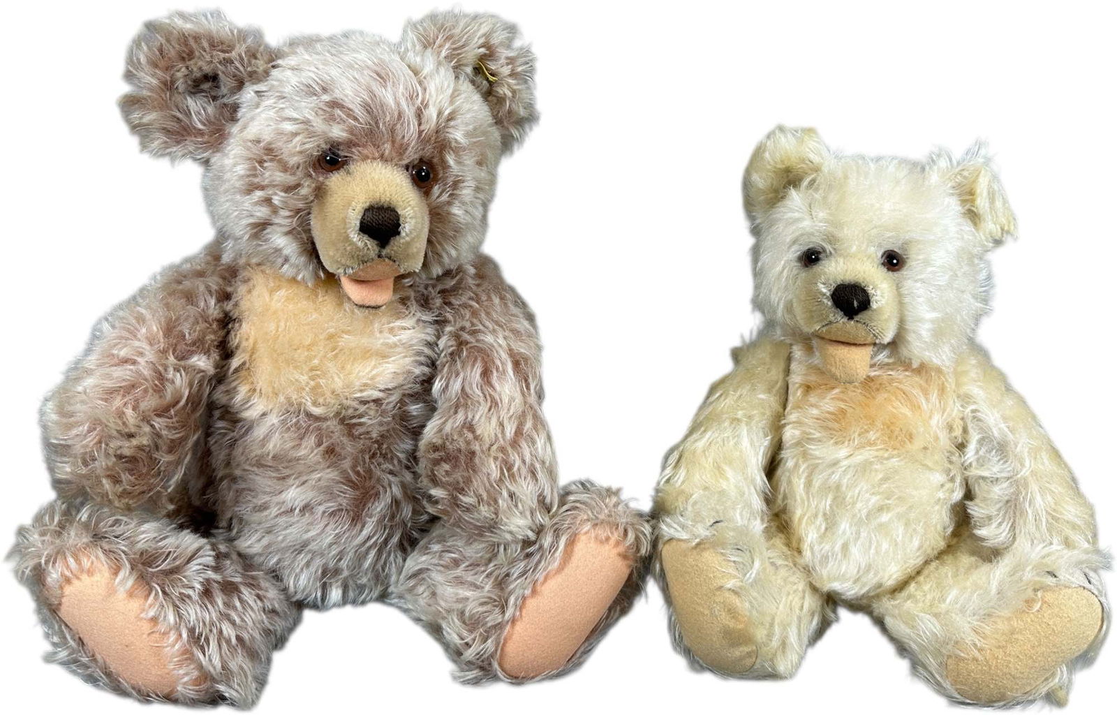 TWO 1950S STEIFF ZOTTY BEARS: 1474. TWO 1950S STEIFF ZOTTY BEARS | Includes one extremely rare white bear that is larger than normally found, and one more traditional colored caramel-tipped mohair bear. | White 14" h., Caramel 18"
