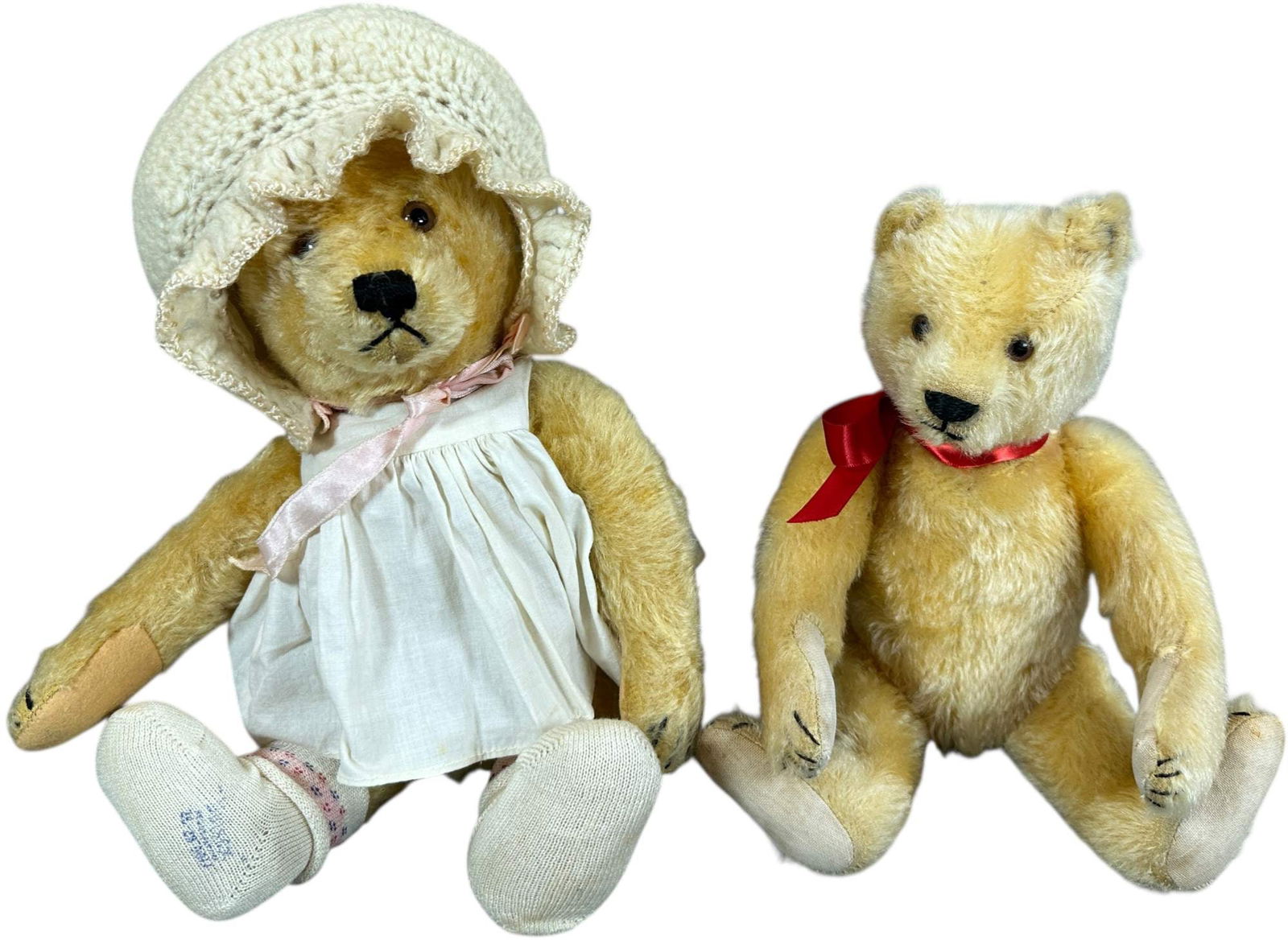 TWO STEIFF APRICOT BEARS: 1477. TWO STEIFF APRICOT BEARS | FF button, squeaker, and linen footpads. | 12" h. | Small pinpoint hole in one pad, overall (Excellent Condition) | $500 - $900