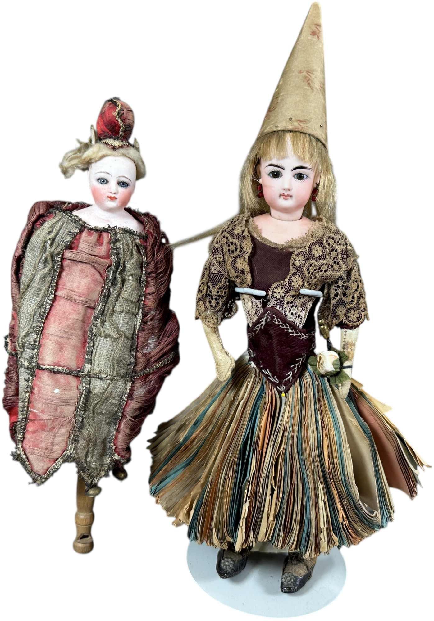 TWO FRENCH BISQUE HEAD NOVELTY DOLLS: 1494. TWO FRENCH BISQUE HEAD NOVELTY DOLLS | All original bisque shoulder head fashion doll, head mounted on a stick and elaborately dressed as a person of wealth and prestige, when shaken, a squeeze