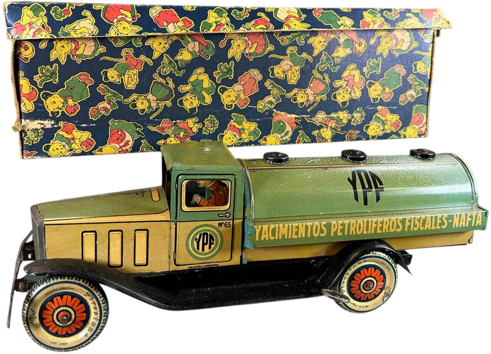 BOXED MATARAZZO ARGENTINA OIL TANKER TRUCK: 121. BOXED MATARAZZO ARGENTINA OIL TANKER TRUCK | Argentina, wind-up driven motion. | 16" l. | Very hard to find with complete original cardboard box, toy is all original with an age patina to the lit