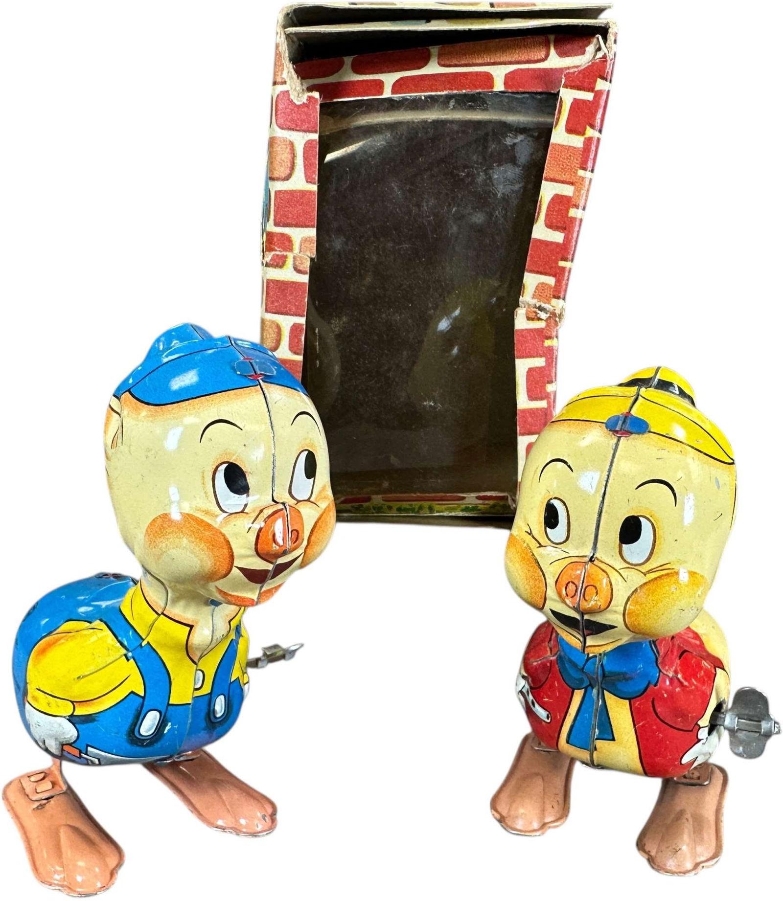 LINEMAR HOPPING LITTLE PIGS: 434. LINEMAR HOPPING LITTLE PIGS | Japan, wind-up motor driven. | 5" h. | Box has two tears at front corners, overall (Excellent Condition) | $300 - $600