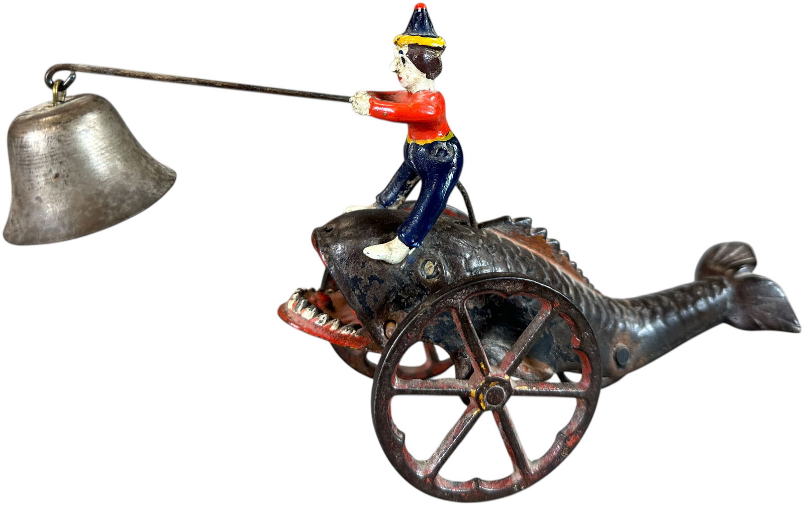 JONAH AND THE WHALE BELL TOY: 71. JONAH AND THE WHALE BELL TOY | Made by Gong Bell. A very popular and charming little toy. Provenance: Richard Mueller Collection. | 8.5" l. | Replacement figure, repaired lower jaw of whale,