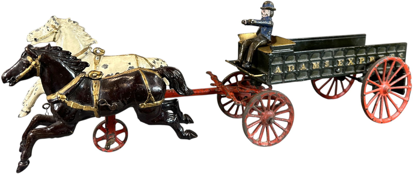 IVES ADAMS EXPRESS WAGON: 119. IVES ADAMS EXPRESS WAGON | This is a really sharp example of this early American toy, complete with original driver and tailgate, with a good cleaning this toy would sparkle. | 21" l. |